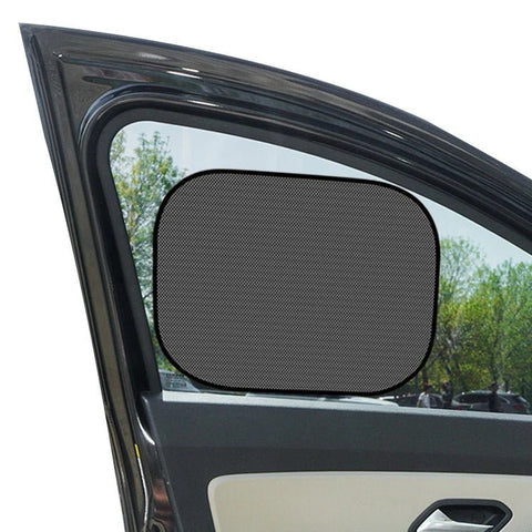 Car window with a sunshade attached, showing a clear view outside.