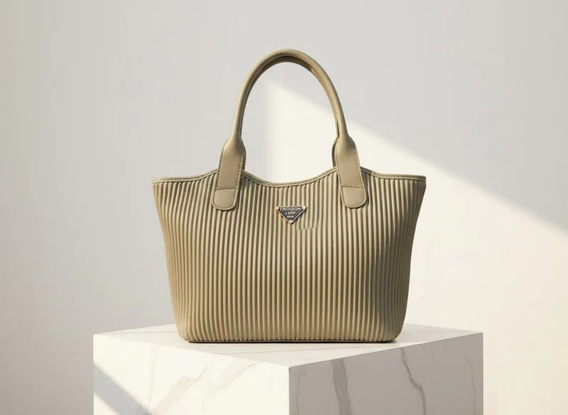 Beige handbag on a white pedestal against a light gray background