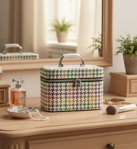 Multicolored patterned makeup case on a wooden dresser with a mirror and decorative items.